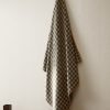 Cotton check-print bath towel with overlock stitching