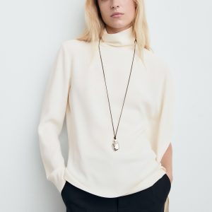High-neck blouse with asymmetrical sleeves