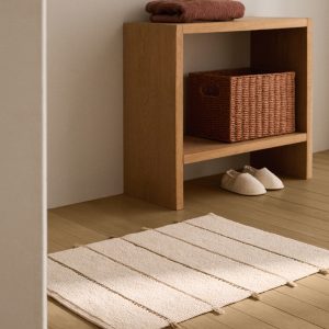 Striped bath mat with fringe detail