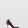 Asymmetrical patent leather court shoes
