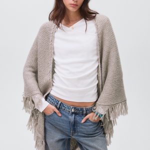 Knitted poncho with tassels